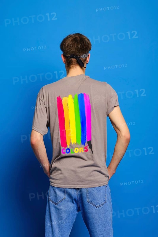 Back view of young man in t-shirt with lgbtq flag on blue background