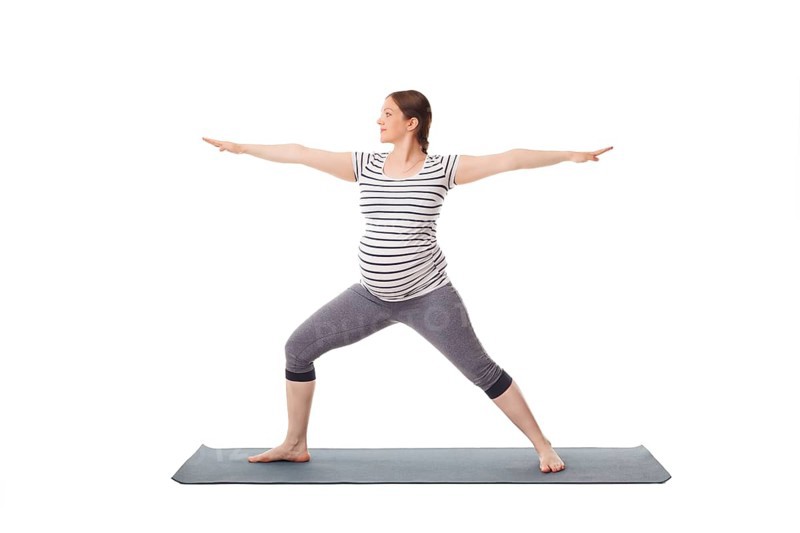 Pregnancy yoga exercise, pregnant woman doing asana virabhadrasana 2, warrior pose isolated on white background