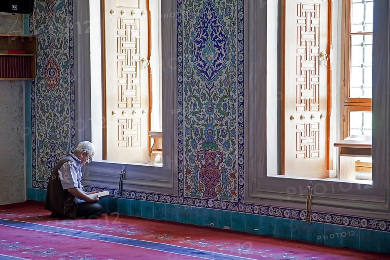 Turkish man reading the Koran in the Kocatepe Camii, largest mosque in Ankara, Turkey, Asia