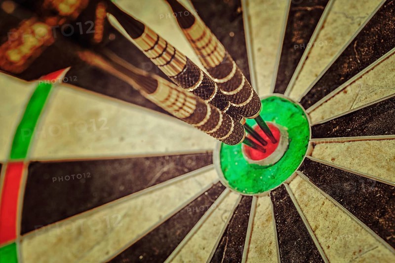 Vintage retro effect filtered hipster style image of, Success hitting target aim goal achievement concept background, three darts in bull's eye close up