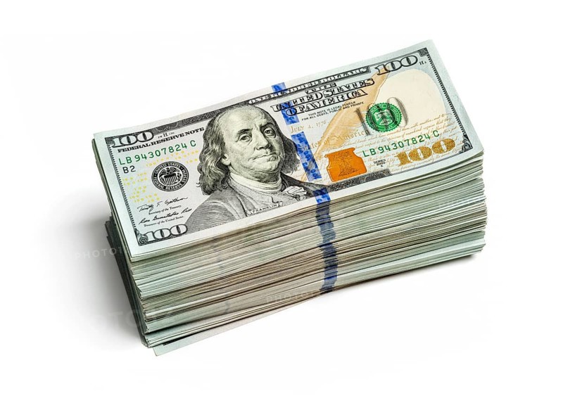 Creative business finance making money concept, stack of bundles of 100 US dollars 2013 edition banknotes bills isolated on white