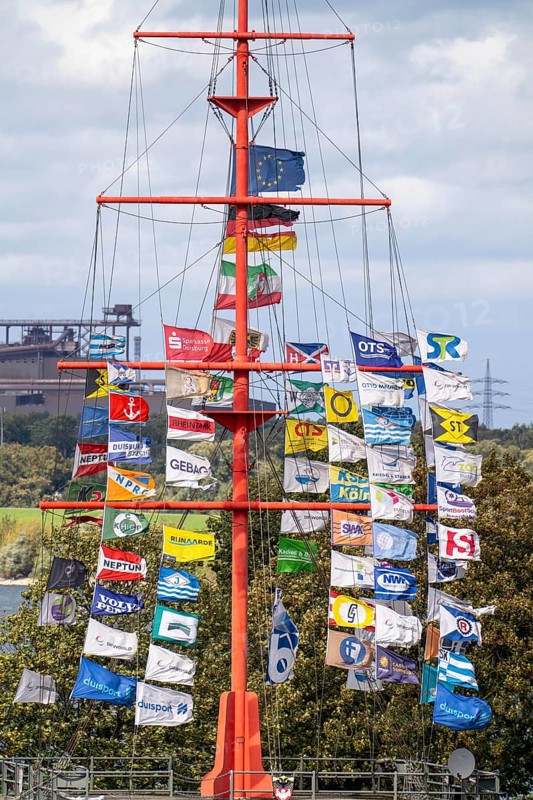 Flagpole on the Mühlenweide, on the Rhine, 38 metre high faithful replica of the mast of a square-rigged sailing ship, decorated with many flags from inland shipping, Duisburg, North Rhine-Westphalia, Germany, Europe