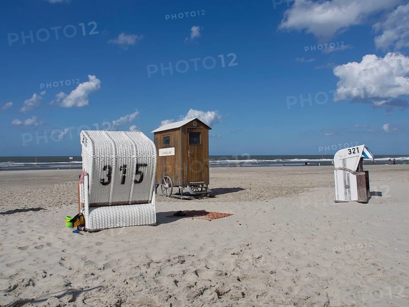 Beach chairs and a wooden hut stand side by side on the quiet beach, spiekeroog, east frisia, north sea, germany