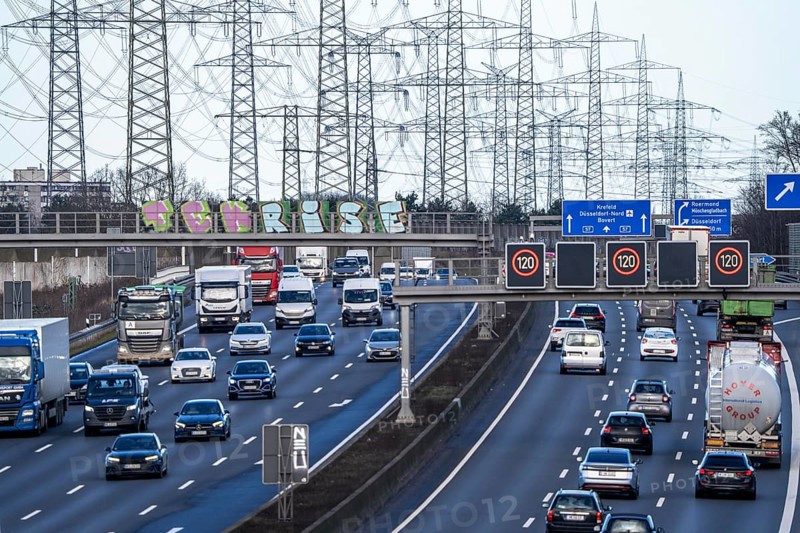 A57 motorway near Kaarst in the Rhine district of Neuss, view in the direction of the Kaarst motorway junction, heavy traffic, overhead power lines, along the motorway, North Rhine-Westphalia, Germany, Europe