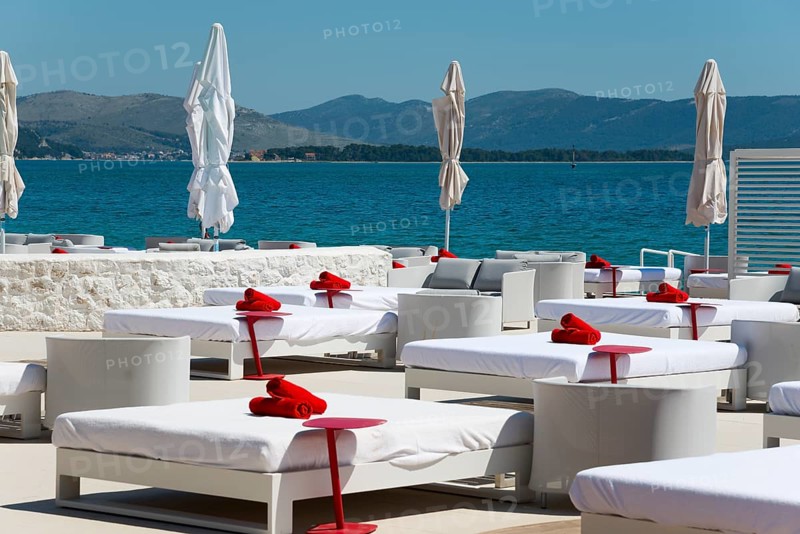 Sunny coastal landscape with white deckchairs and views of the calm blue sea, Amadria Park, En Vogue Beach Club, Šibenik, Sibenik, Dalmatia, Croatia, Europe