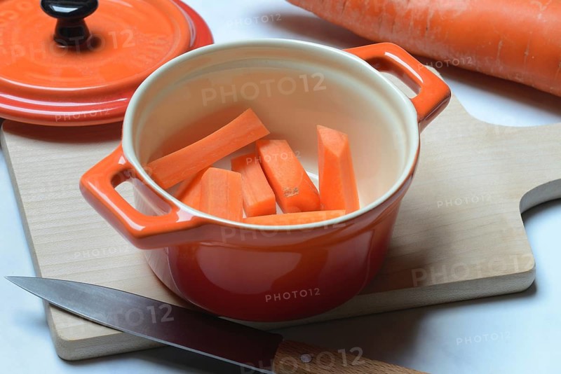 Carrot, carrot sticks in pot and kitchen knife