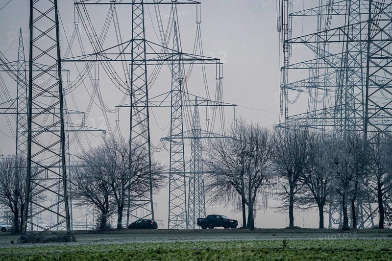 Large power line, 380 KV extra-high voltage lines, near Rommerskirchen, in fog, winter, country road L93 to Stommeln, North Rhine-Westphalia, Germany, Europe