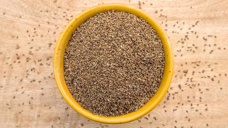 Carom Seeds, Thymol Seeds, Bishop's Weed, Ajwain in a Yellow Bowl, Flat Lay