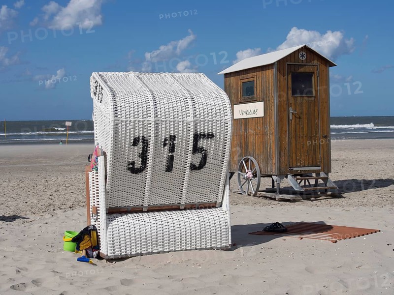 White beach chair and wooden hut on the beach under a blue sky, spiekeroog, east frisia, north sea, germany