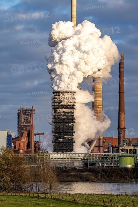 Industrial backdrop of the ThyssenKrupp Steel steelworks in Duisburg-Bruckhausen, on the Rhine, blast furnaces, Schwelgern coking plant, extinguishing cloud, Duisburg, North Rhine-Westphalia, Germany, Europe