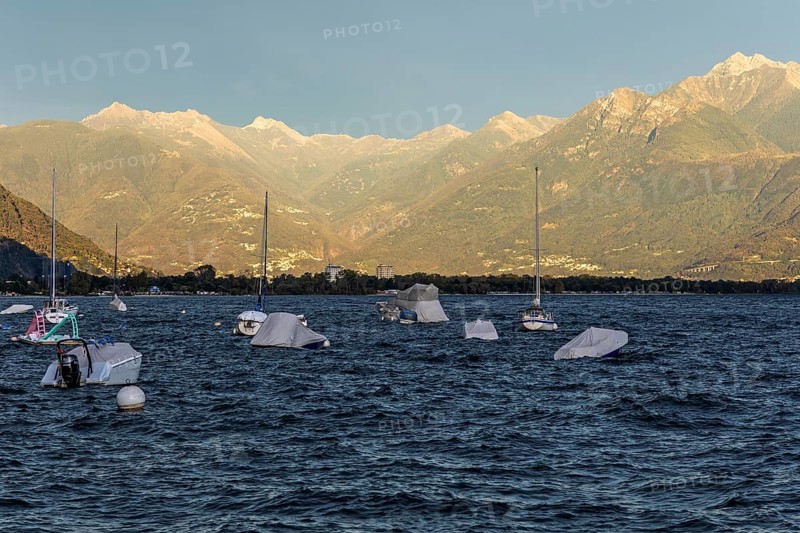 Boats lying in the water, Locarno, Lake Maggiore, surrounding mountains in the evening light, Canton Ticino, Switzerland, Europe
