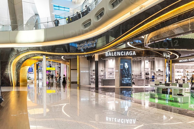 Abu Dhabi Airport, Zayed International Airport with passengers. Duty free shop of the fashion brand Balenciaga. The new Terminal A has a capacity of 45 million passengers per year. Modern architecture. Abu Dhabi, United Arab Emirates, UAE, Asia