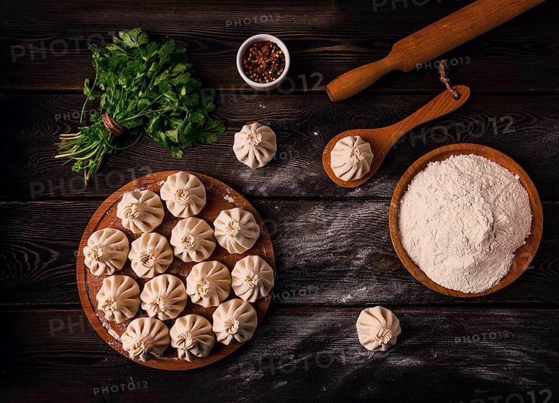 Raw khinkali, Traditional Georgian dish, on a wooden table, selective focus, rustic, no people
