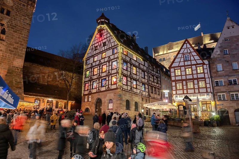 Historic Pilkatushaus with an Advent calendar on 18 December 2024 at dusk, behind the Imperial Castle, Tiergärtnertorplatz, Nuremberg, Middle Franconia, Bavaria, Germany, Europe