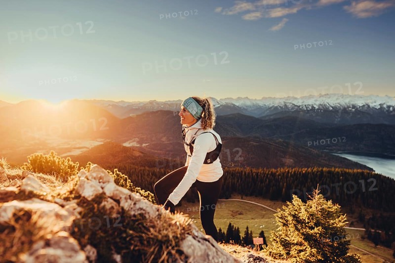 Trail running in autumn on the Jochberg on Lake Walchensee against the wonderful backdrop of the Alps, Bavaria, Germany, Europe