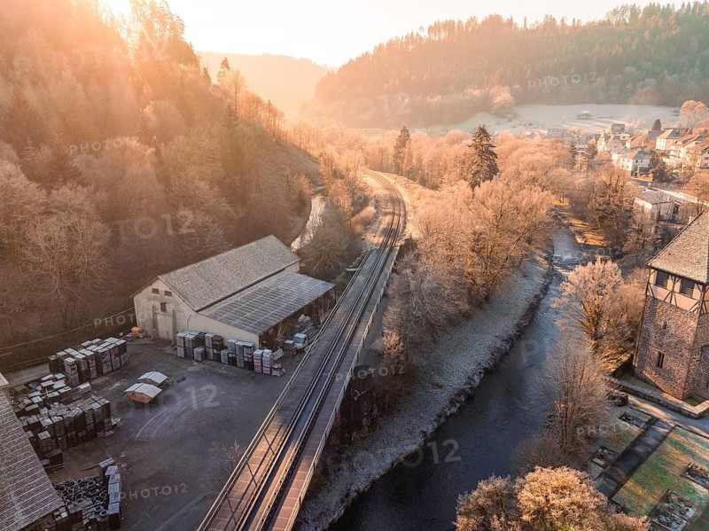 Sunset over a railway line and river, bordering a village and wooded hills, Kentheim, district of Calw, Black Forest, Germany, Europe