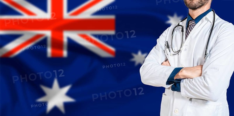 Male Doctor holding stethoscope on Australian flag. Doctor with stethoscope on Australia flag