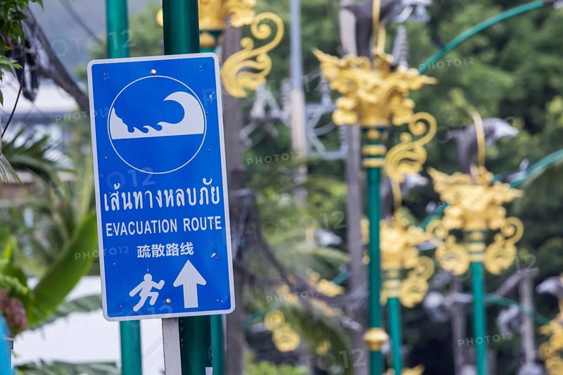 Tsunami Hazard Zone. Warning sign, signposting of escape routes in the event of another seaquake. Beach area and coastal road in the town of Patong, Kathu, Phuket Island, Thailand, Asia