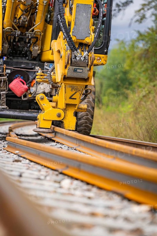Yellow construction machine working on a railway track on ballast, track construction, Hermann Hessebahn, Calw, Black Forest, Germany, Europe