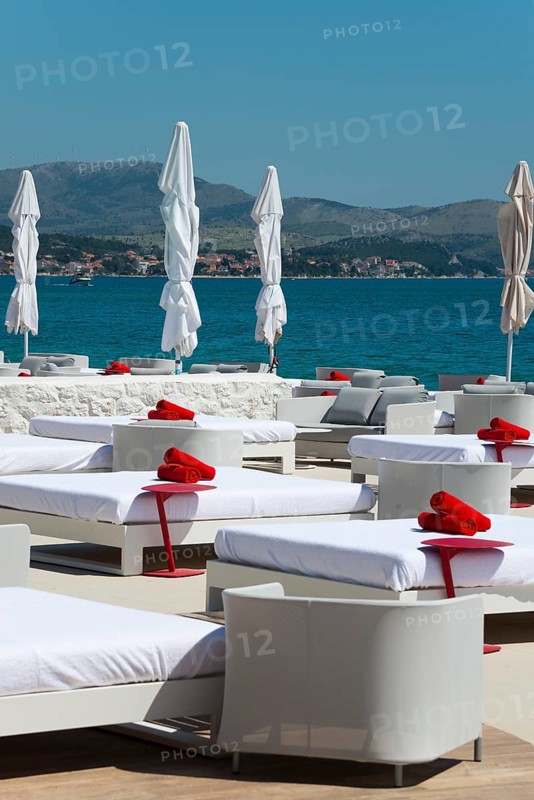 White deckchairs with red towels on the coast overlooking the sea, Amadria Park, En Vogue Beach Club, Šibenik, Sibenik, Dalmatia, Croatia, Europe