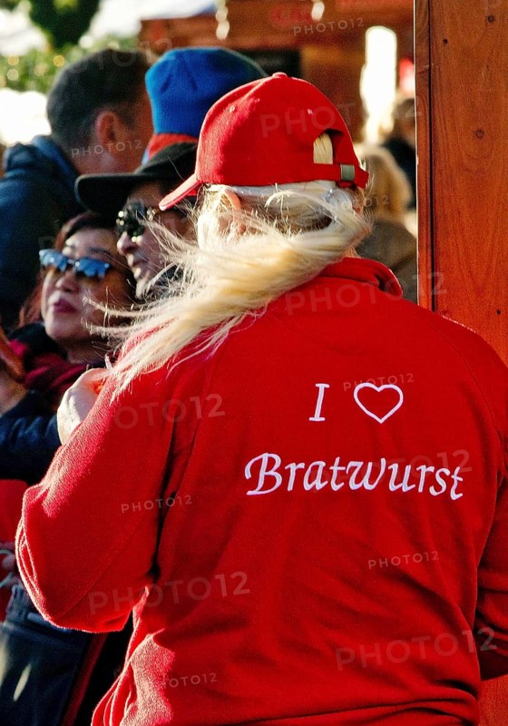 I love Bratwurst, print on the red clothing of a saleswoman at the Christmas market, Düsseldorf, North Rhine-Westphalia, Germany, Europe