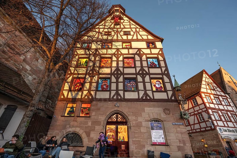 Main facade of the Pilatushaus with 15 windows of the Advent calendar created by the Alstadtfreunde Nürnberg, Tiergärtnertorplatz, Nuremberg, Central Franconia, Bavaria, Germany, Europe