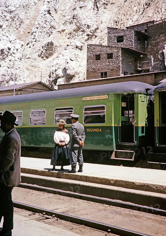 Indigenous woman and railway official standing on the platform at the train, La Oroya railway station, Peru, South America around 1962, South America