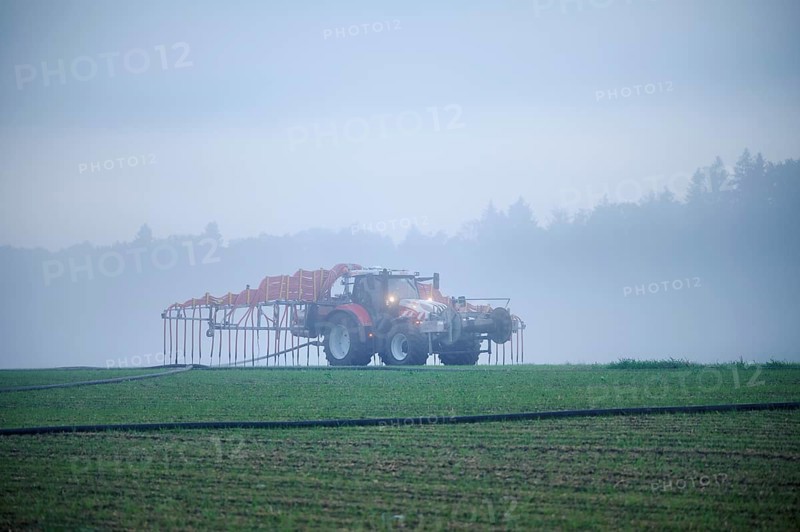 Farmer with tractor fertilising, Rottenschwil, Canton Aargau, Switzerland, Europe
