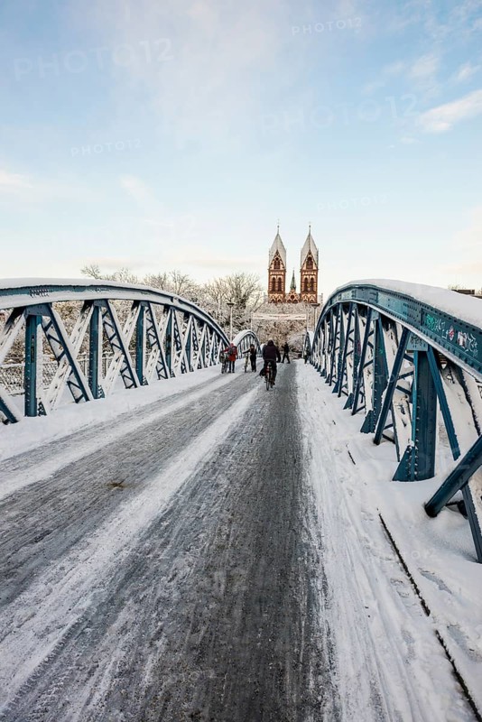 Bridge with snow and ice and cyclists, Blue Bridge and Stühlinger Church, Freiburg im Breisgau, Black Forest, Baden-Württemberg, Germany, Europe