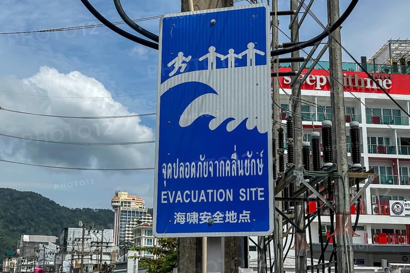 Tsunami Hazard Zone. Warning sign, signposting of escape routes in the event of another seaquake. Beach area and coastal road in the town of Patong, Kathu, Phuket Island, Thailand, Asia
