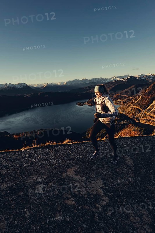 Trail running in autumn on the Jochberg on Lake Walchensee against the wonderful backdrop of the Alps, Bavaria, Germany, Europe