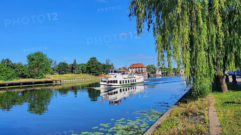 A peaceful river landscape with a boat and overhanging trees, Birkut ship, Elblag River, Elblag, Elbing, Warminsko-Mazurskie Voivodeship, Warminsko-Mazurskie, Poland, Europe
