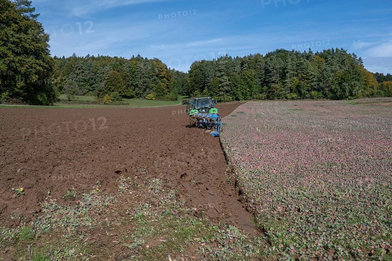 Farmer with tractor ploughing his field with a 5-turn rotary plough, Franconia, Bavaria, Germany, Europe