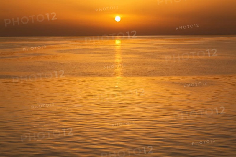 Setting golden sun over Adriatic sea taken from the top deck of a cruise ship in late summer, near Zadar, Croatia, Europe