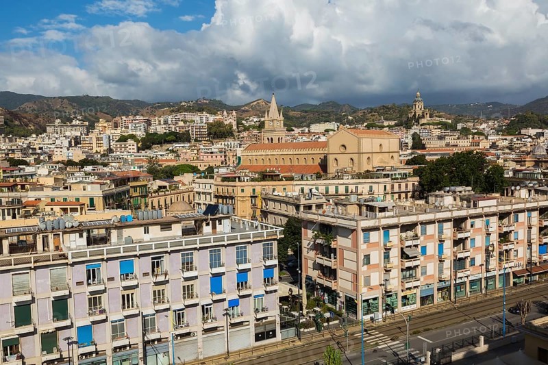 High angle view of Messina city skyline with storm clouds gathering in late summer, Sicily, Italy, Europe