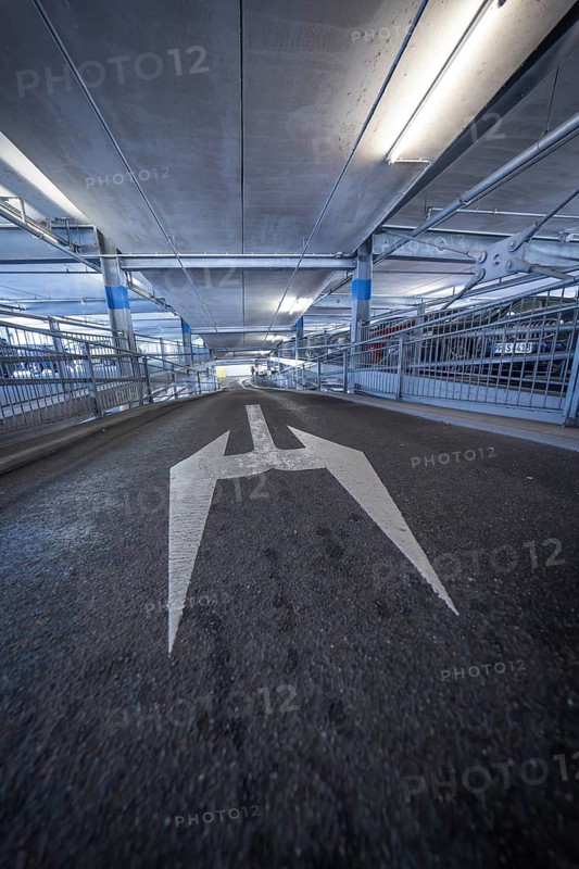 Driveway in a multi-storey car park with large directional arrow on the carriageway, Kaufland Calw multi-storey car park, Calw district, Black Forest, Germany, Europe