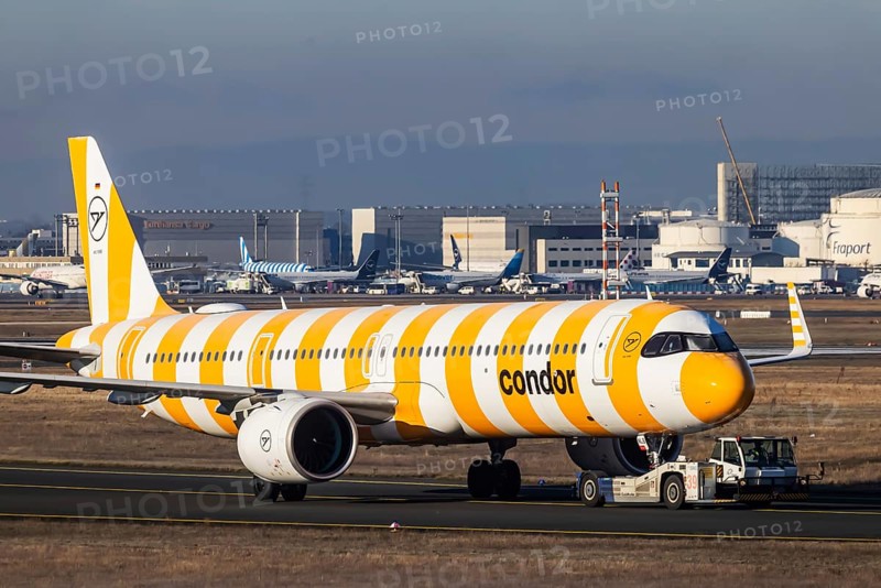 A Condor holiday airline aircraft is towed to the terminal by an aircraft tractor. Aircraft registration number: D-ANLB, Airbus A321neo. Fraport Airport, Frankfurt am Main, Hesse, Germany, Europe