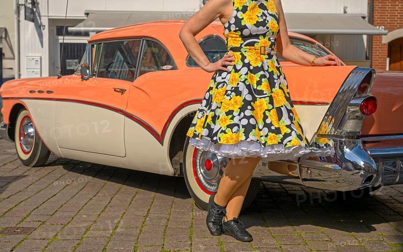 Vintage American road cruiser Buick with woman and petticoat