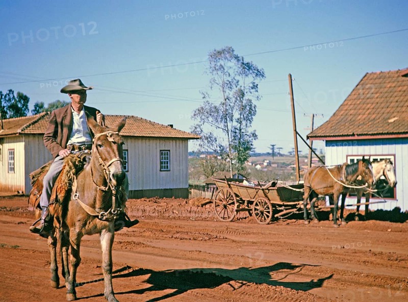 Man on horseback riding through the street in Laranjeiras do Sol, state of Paraná, Brazil, 1962, South America