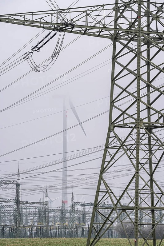 Wind farm in the fog, high-voltage pylons, dark doldrums, no wind no direct sunlight, in the Rhenish lignite mining area, south of Rommerskirchen North Rhine-Westphalia, Germany, Europe