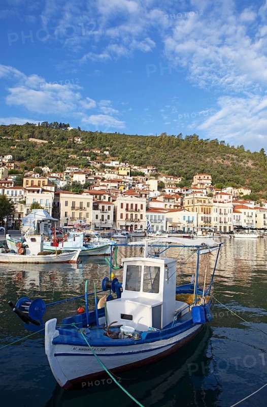 Small fishing boats in the Mediterranean harbour of Gythio or Gythion, behind houses and the Taygetos Mountains, Mani Peloponnese, Greece, Europe