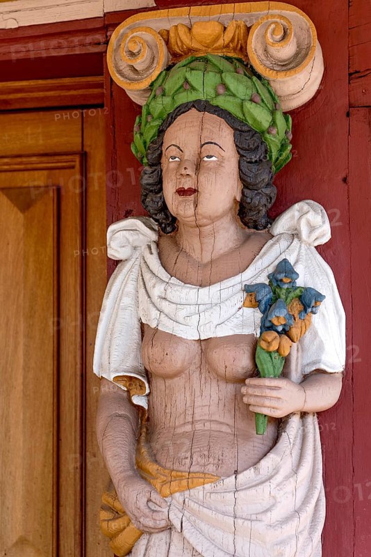 Atlant, figure of a woman with naked upper body, breasts, colourfully painted carving on the portal to the town hall, historic half-timbered house of the Renaissance, old town, Hadamar, Limburg-Weilburg, Westerwald, Hesse, Germany, Europe