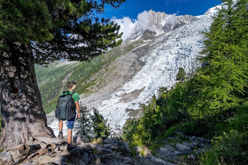 Mountaineer in front of impressive mountain landscape with glacier, view of Glacier des Bossons and summit of Aiguille du Midi, hike La Jonction, Chamonix, Haute-Savoie, France, Europe