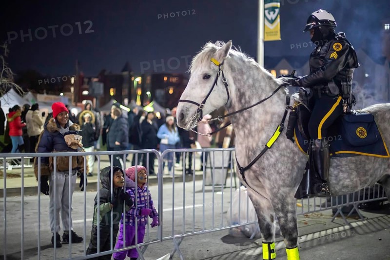 Detroit, Michigan - Children admire a police horse during Noel Night. The annual event at the beginning of the holiday season in Detroit features open houses by arts and cultural institutions, churches, and small businesses.