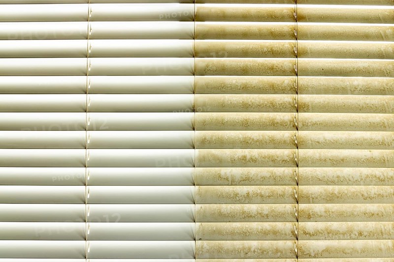 Residential window shades showing the before and after of a good cleaning, one side clean and one side dirty