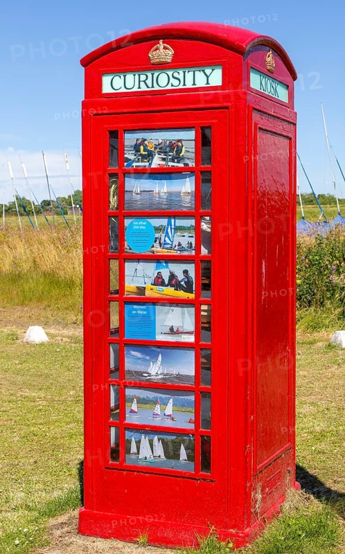 Red K6 telephone box repurposed as local curiosity information booth, Felixstowe Ferry, Suffolk, England, Uk