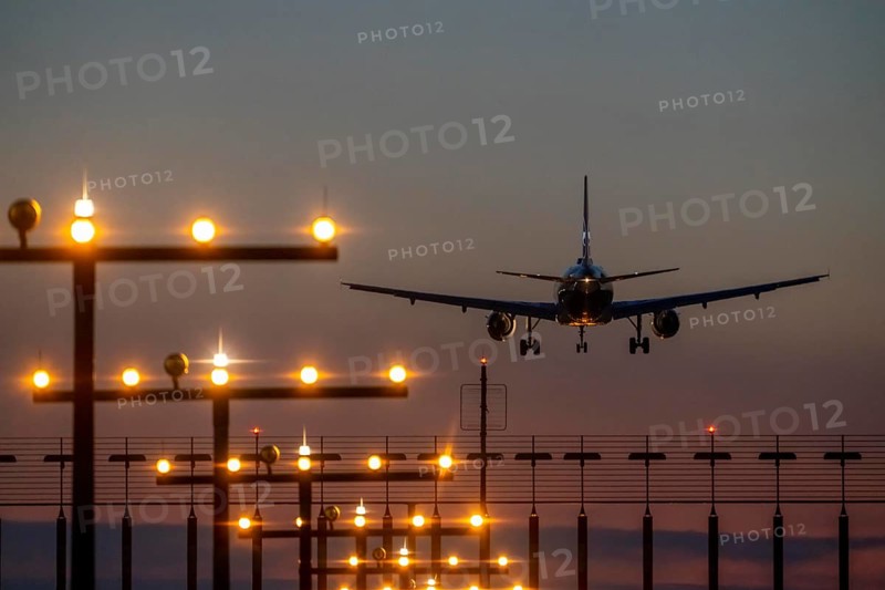 Aircraft approaching the main runway south, 05R/23L, runway lighting, approach aids, at Düsseldorf International Airport, sunset, North Rhine-Westphalia, Germany, Europe