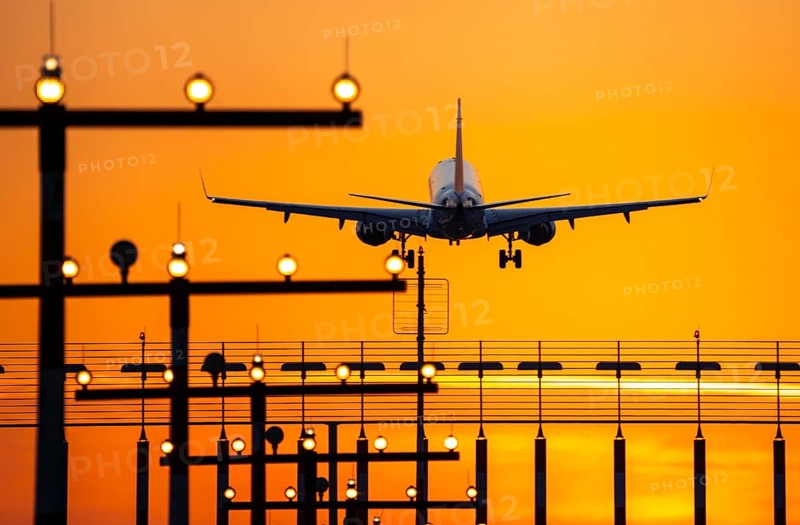 Aircraft approaching the main runway south, 05R/23L, runway lighting, approach aids, at Düsseldorf International Airport, sunset, North Rhine-Westphalia, Germany, Europe