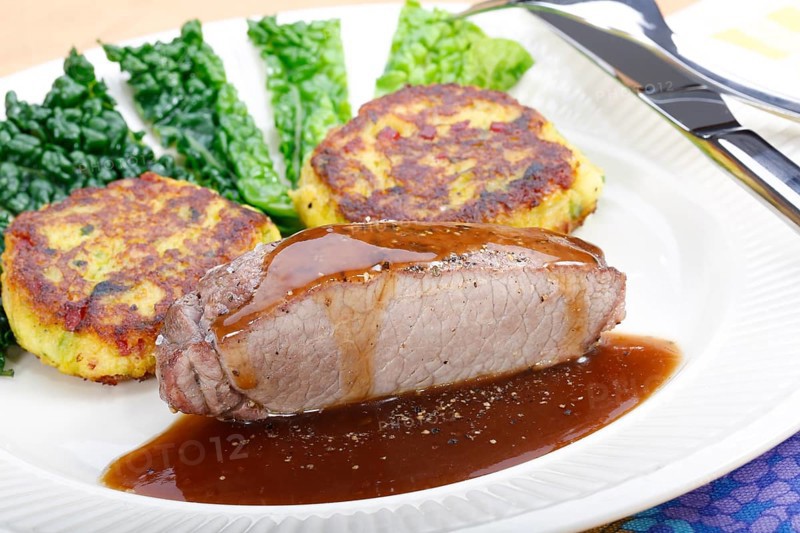 Swabian cuisine, medallions of wild boar with savoy cabbage cakes, meat dish, roasted, hearty, home cooking, typical Swabian, arranged on a plate, traditional cuisine reinterpreted, food photography, studio, Germany, Europe