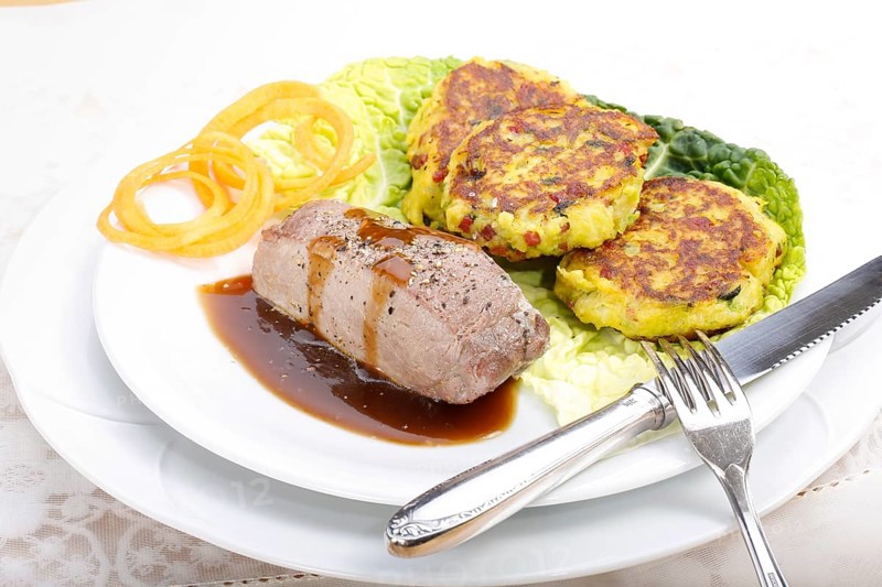 Swabian cuisine, medallions of wild boar with savoy cabbage cakes, meat dish, roasted, hearty, home cooking, typical Swabian, arranged on a plate, traditional cuisine reinterpreted, food photography, studio, Germany, Europe